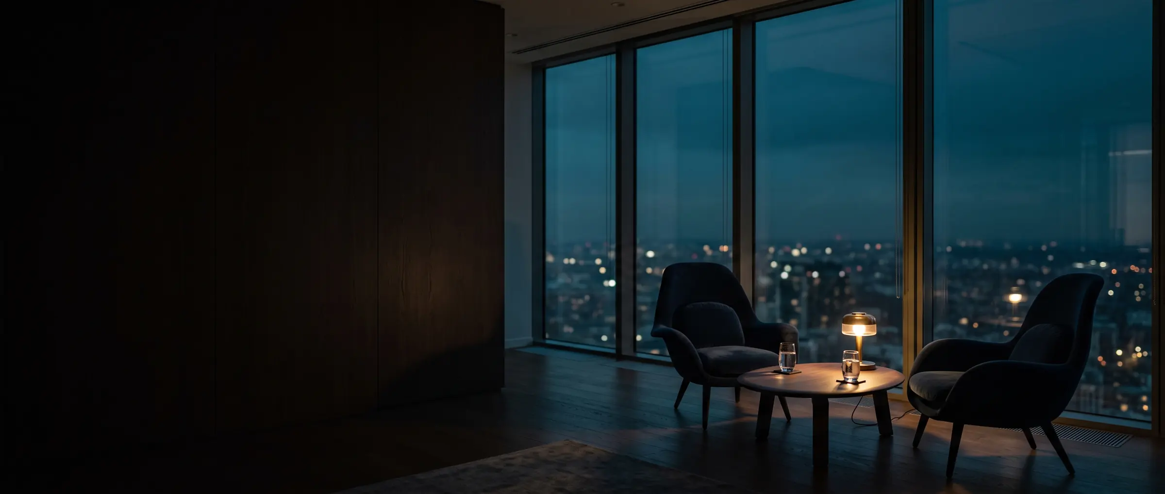 Two chairs angled towards each other in a quiet office at dusk